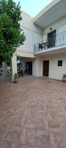 an empty courtyard of a building with a balcony at Tsanis in Parga
