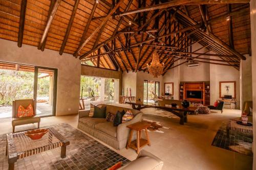 a living room with a couch and a table at Kapama Southern Camp in Kapama Private Game Reserve