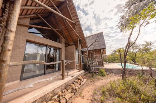 an exterior view of a house with a swimming pool at Kapama Southern Camp in Kapama Private Game Reserve