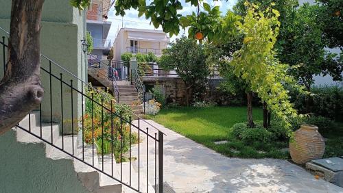 a wrought iron stairway leading up to a house at Betty's Garden House in Nea Anchialos