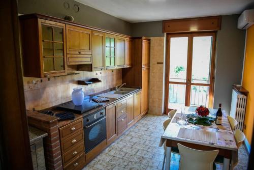 una cocina con armarios de madera y una mesa con mesa. en Cascina Speronetti, en Canale