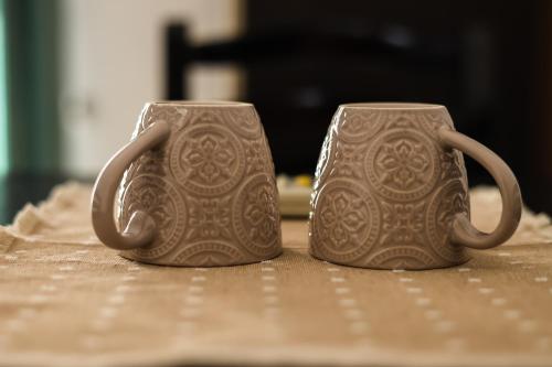 two mugs sitting on top of a table at Vila Zhiti in Durrës