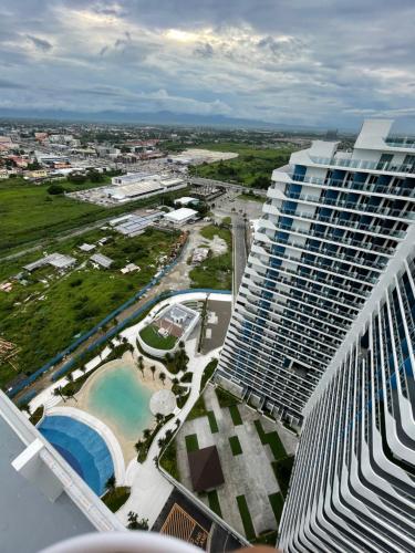 an aerial view of a large building with a pool at Analiza Penthouse Azure North in San Fernando