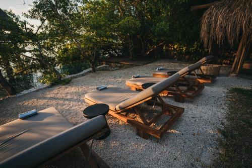 a row of chaise lounges are lined up at Kokoro Mio Hotel & Wellnes in Xul-Ha