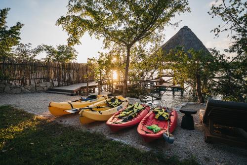 a group of kayaks are lined up on the ground at Kokoro Mio Hotel & Wellnes in Xul-Ha