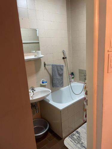 a bathroom with a sink and a tub and a toilet at Urban Apartment in Sarajevo