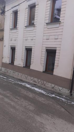 a white building with windows on the side of it at Luni in Travnik