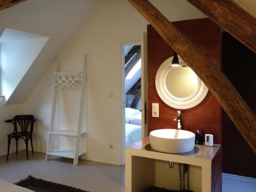 a bathroom with a sink and a mirror at L'oisellerie Cottages in Le Renouard