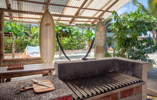 a surfboard sitting next to a grill with a surfboard at La Casa Mompiche in Mompiche