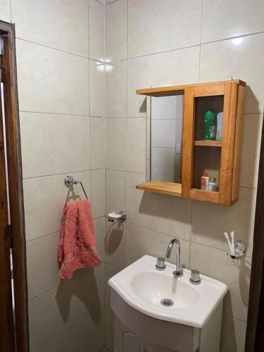 a white bathroom with a sink and a mirror at Nuestro Rancho Chapadamalal in Colonia Chapadmalal