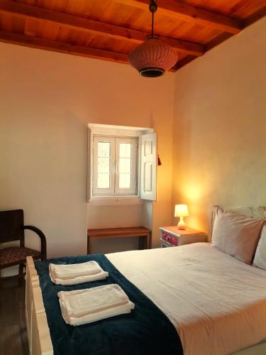 a bedroom with a bed with two towels on it at Quinta Santo António in Pereiro da Palhacana