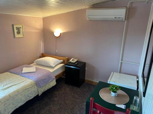 a hotel room with two beds and a table at Hondo Rooms & Apartments in Sarajevo