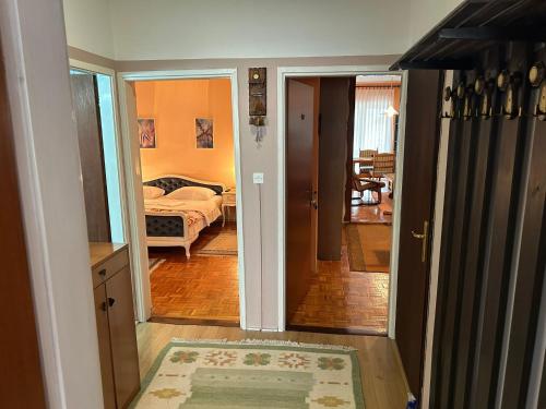 a room with a bedroom with a bed and a hallway at Hondo Rooms & Apartments in Sarajevo