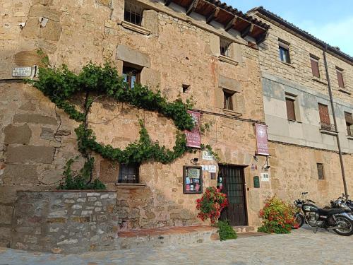 a building with a motorcycle parked in front of it at Hotel Rural el Arrabal Siguenza in Sigüenza