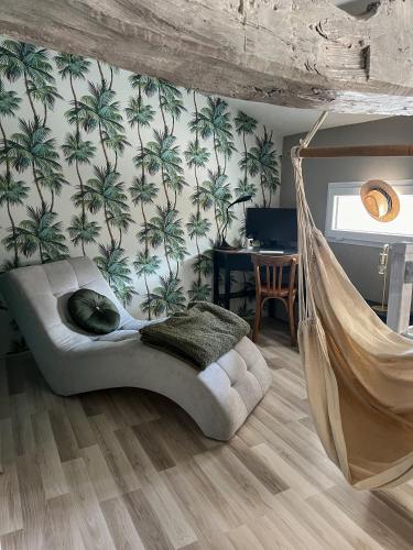 une chambre avec un lit pivotant avec un hamac dans l'établissement Maison proche de l'Estuaire, à Brie-sous-Mortagne