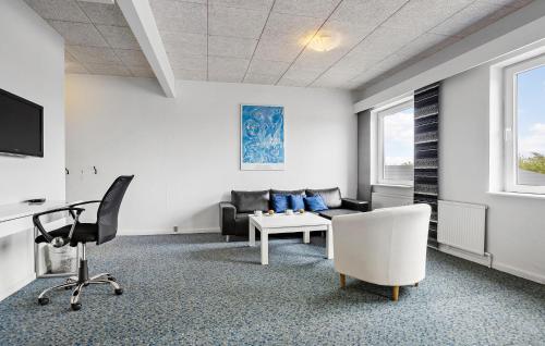 a living room with a couch and a chair at 11 Bedroom Gorgeous Home In Hurup Thy in Hurup