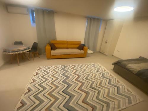 a living room with a couch and a bed at Podgorica 23 in Podgorica