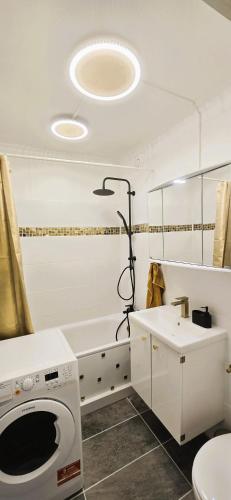 a bathroom with a washing machine and a sink at Let's RelaxX Luxury class in Mülheim an der Ruhr