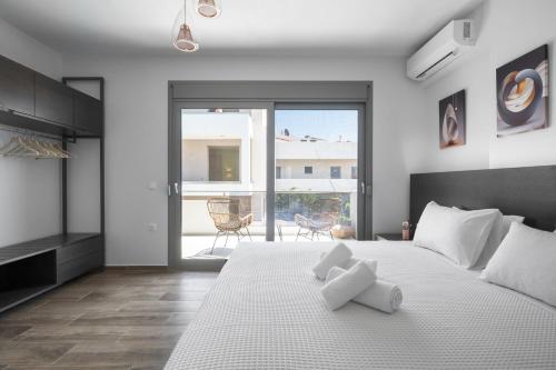a bedroom with a bed with two white towels on it at Nikiti Summer Gem 1 by Luxlikehome in Nikiti
