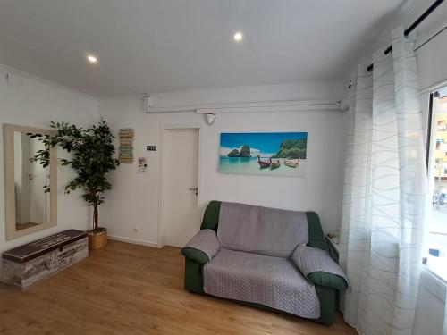 a living room with a couch and a window at Aeropuerto Barcelona -Mi colibrí in El Prat de Llobregat