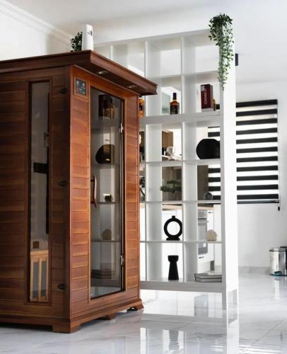 a wooden cabinet with glass doors in a room at Vila Grof in Vinča