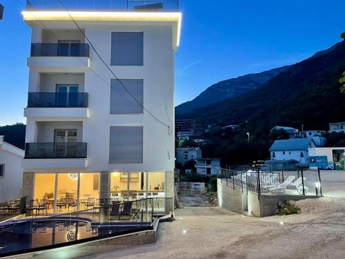 a white building with a view of a mountain at Relax Apartmani in Sutomore