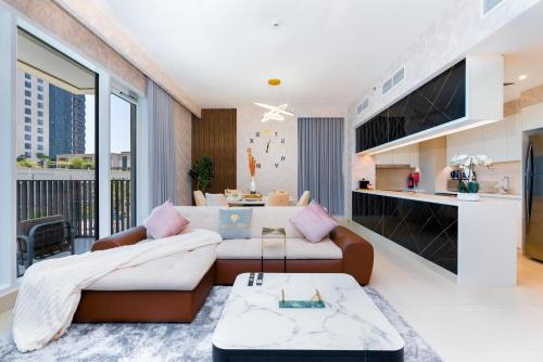 a living room with a couch and a table at Globalstay Creek Horizon Modern Apartments in Dubai