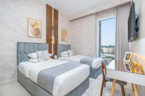 a hotel room with two beds and a desk and a television at Globalstay Creek Horizon Modern Apartments in Dubai