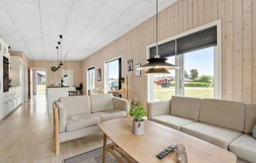 a living room with two couches and a table at Pet Friendly Home In Hemmet With Wifi in Hemmet