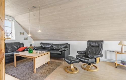 a living room with leather furniture and a table at 4 Bedroom Stunning Home In Fanø in Fanø