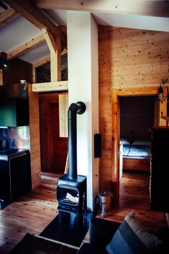 a woodburning stove in a room with a bedroom at Ferienhaus am Teich in Kappel am Krappfeld
