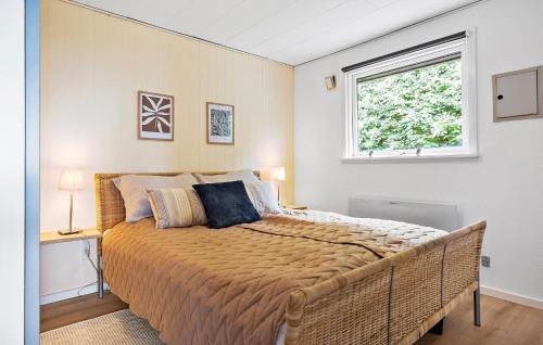 a bedroom with a large bed and a window at Nice Home In Kalundborg in Kalundborg