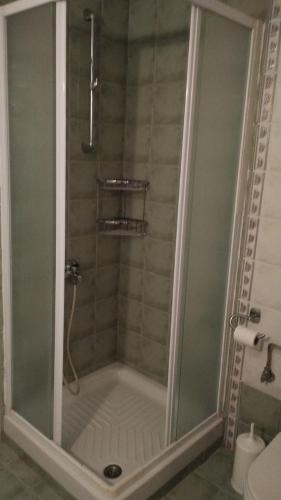 a shower with a glass door in a bathroom at Zeusplace karia Villa Natura in Leptokaria
