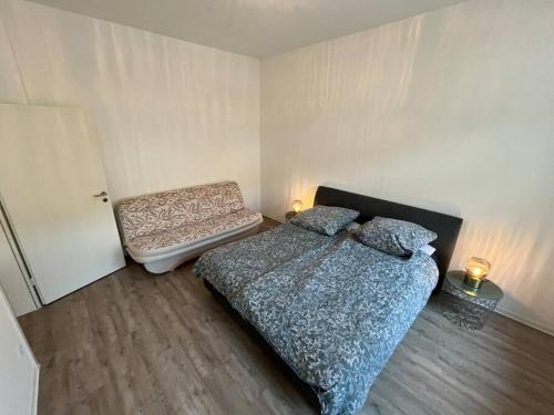 a bedroom with a bed and a chair at Small Sally in Gladbeck