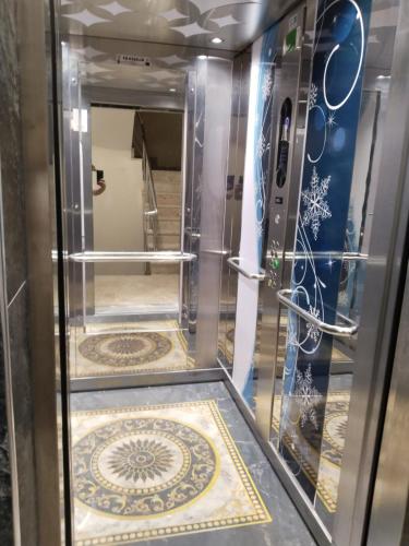 an elevator in a room with a tile floor at LOYA APARTMENTs in Trabzon