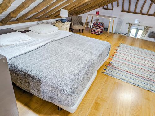 a bedroom with a large bed and a rug at Casa Baleia Laranja Ocean-Front in Madalena
