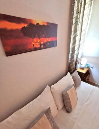 a living room with a couch and a painting on the wall at Rent Apartment - SKALA ERESOS LESVOS in Skala Eresou