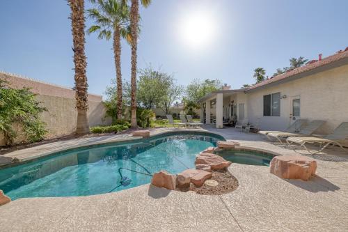 a swimming pool in front of a house with palm trees at Lucky Getaway LV in Las Vegas