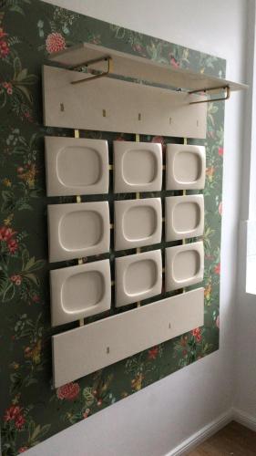 a bathroom with white urinals on a wall at Ferienwohnung in Bleckede in Bleckede