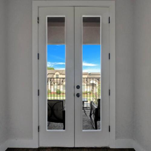 a white door with a view of a balcony at Timeless Beauty in Denton
