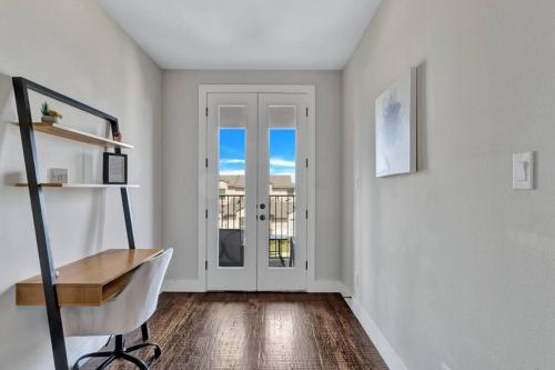 a white room with a chair and a door at Timeless Beauty in Denton