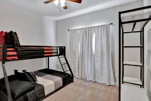 a bedroom with two bunk beds and a ceiling fan at Timeless Beauty in Denton