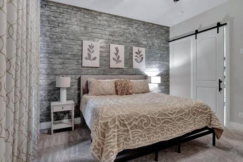 a bedroom with a bed and a brick wall at Timeless Beauty in Denton