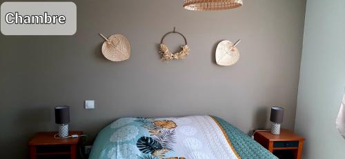 a bedroom with a bed with two night stands and two tables at Appartement cosy 4 personnes in Benesse-lez Dax