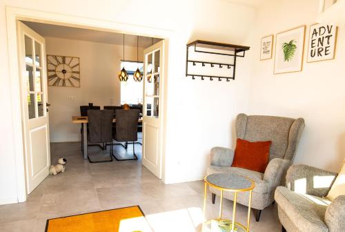a living room with a couch and a table at HeideFunHaus 2 in Neuenkirchen