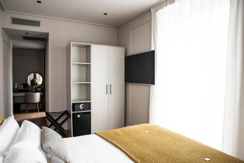 a bedroom with a bed and a white cabinet at Soho Boutique Palacio de Pombo in Santander