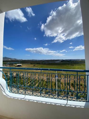 a view of a field from a balcony at Résidence riad sofia in Martil