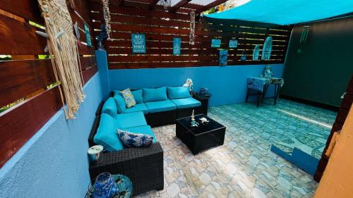 a living room with a blue couch and a table at Blue Paradise in Prospect Park