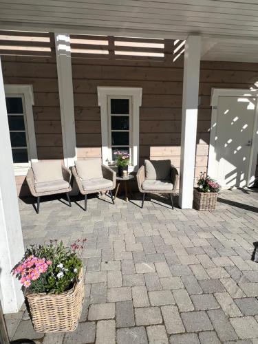 a patio with two chairs and a table with flowers at Lapland Lodge in Arvidsjaur