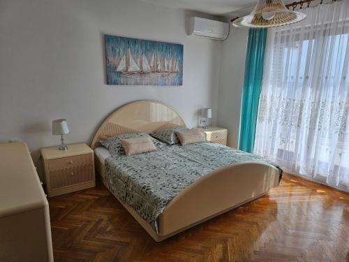 a bedroom with a large bed in a room at Apartments Cavar in Rab